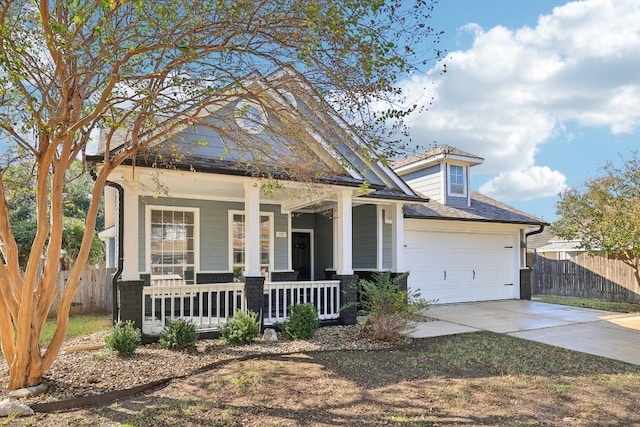 view of front of property featuring a porch and a garage