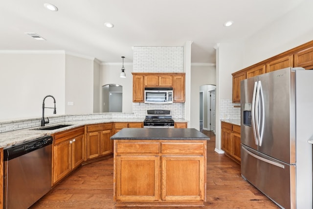 kitchen with a center island, light wood-type flooring, sink, and appliances with stainless steel finishes