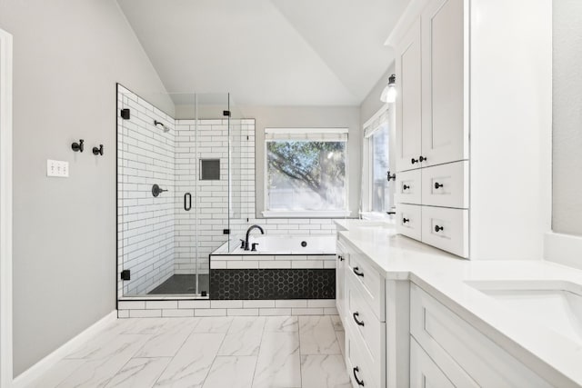 bathroom with vanity, lofted ceiling, and shower with separate bathtub