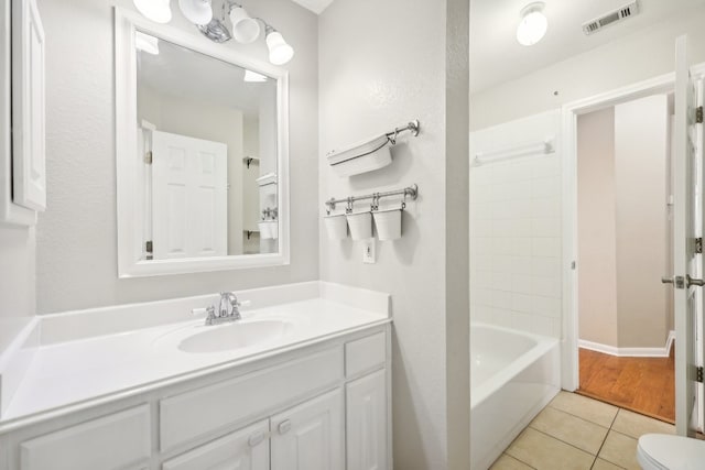 full bathroom featuring tile patterned floors, vanity, toilet, and bathing tub / shower combination