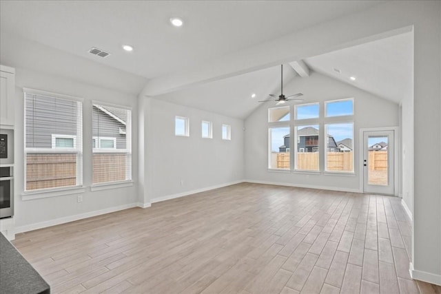 unfurnished living room featuring visible vents, baseboards, light wood-style flooring, vaulted ceiling with beams, and recessed lighting