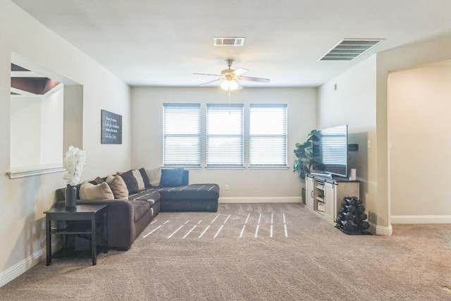 carpeted living room with ceiling fan