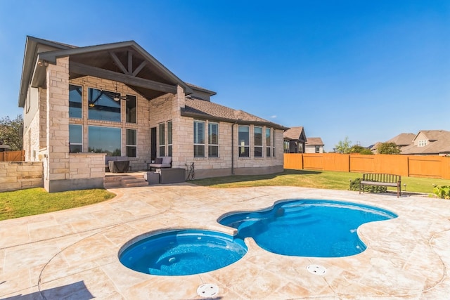 view of pool with a lawn, an in ground hot tub, and a patio