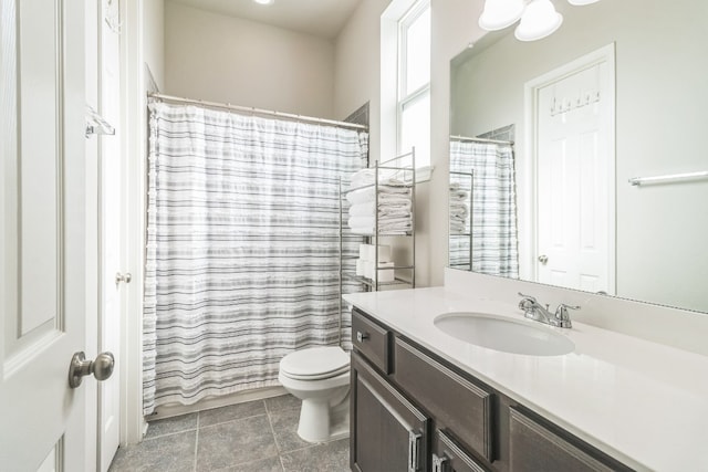 bathroom featuring tile patterned floors, a shower with curtain, vanity, and toilet