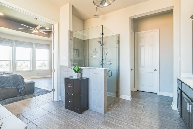 bathroom featuring walk in shower, vanity, ceiling fan, and tile patterned flooring