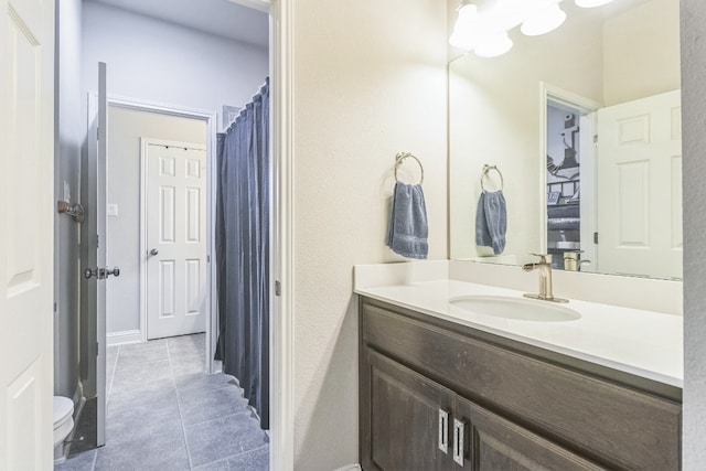 bathroom with tile patterned floors, vanity, and toilet