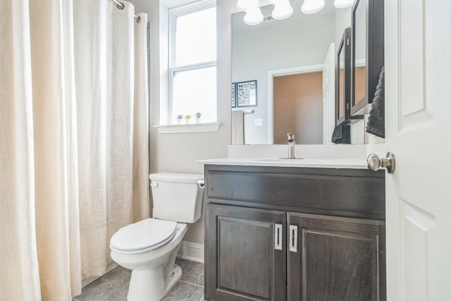 bathroom with tile patterned flooring, vanity, curtained shower, and toilet