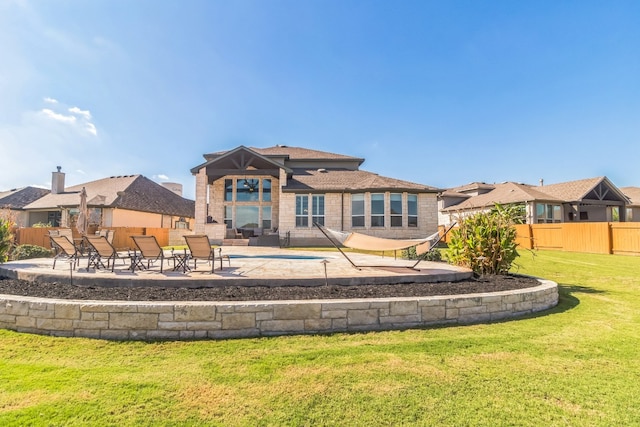 rear view of property featuring a yard and a patio