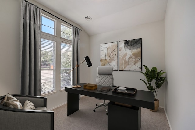 carpeted office space featuring vaulted ceiling