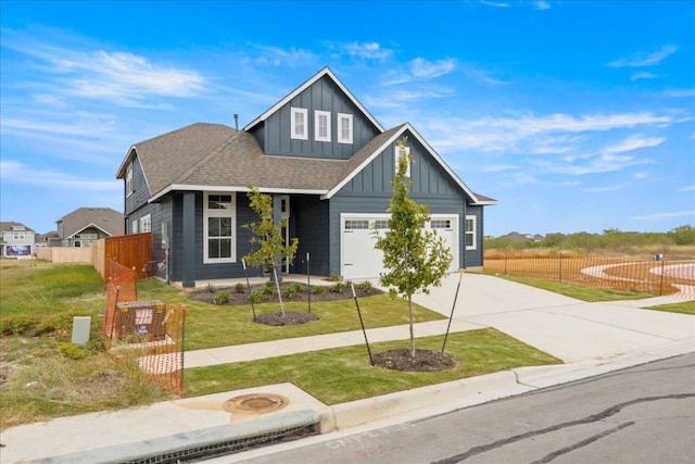 craftsman house featuring a front yard and a garage