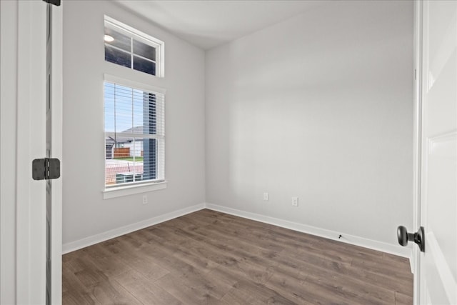 spare room with dark hardwood / wood-style floors