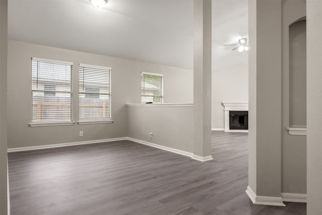 unfurnished room with hardwood / wood-style flooring, ceiling fan, and vaulted ceiling