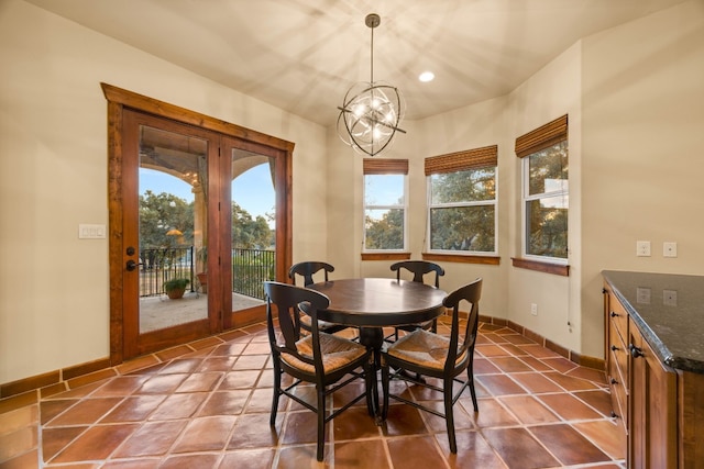 dining space with tile patterned floors and a notable chandelier