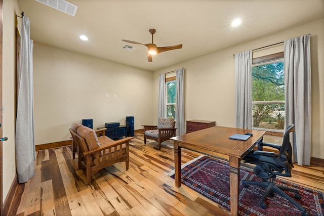 office featuring a wealth of natural light, ceiling fan, and light hardwood / wood-style floors