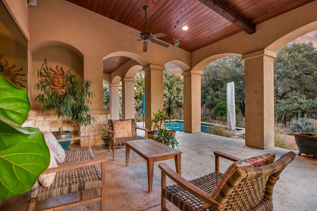 view of patio with a fenced in pool and ceiling fan