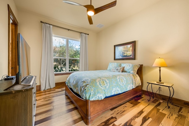 bedroom with ceiling fan and light hardwood / wood-style flooring