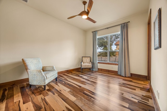 sitting room featuring wood-type flooring, vaulted ceiling, and ceiling fan