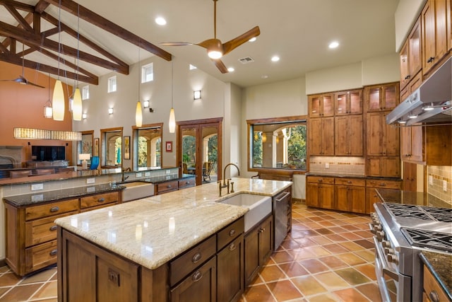 kitchen with decorative light fixtures, a spacious island, appliances with stainless steel finishes, and tasteful backsplash