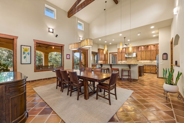 tiled dining room featuring beamed ceiling and high vaulted ceiling