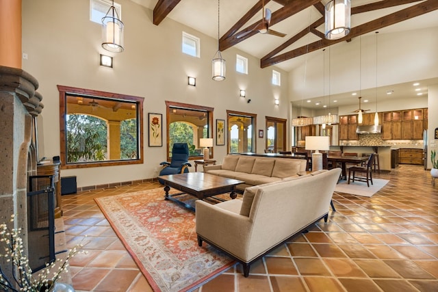 living room featuring beam ceiling, high vaulted ceiling, ceiling fan, and tile patterned floors