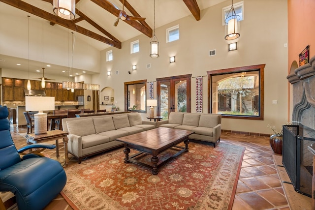 living room with beam ceiling, tile patterned flooring, high vaulted ceiling, and french doors