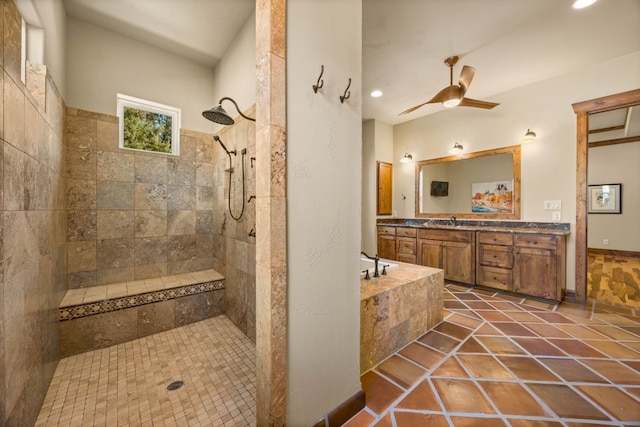 bathroom featuring a tile shower, ceiling fan, tile patterned floors, and vanity