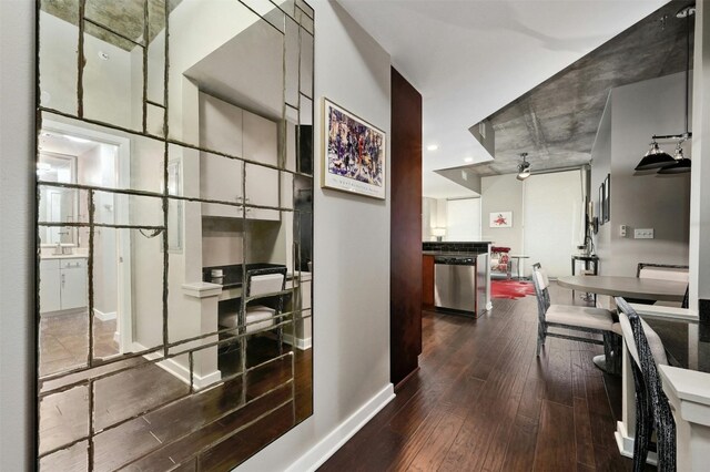 interior space with stainless steel dishwasher, ceiling fan, white cabinetry, and hardwood / wood-style flooring