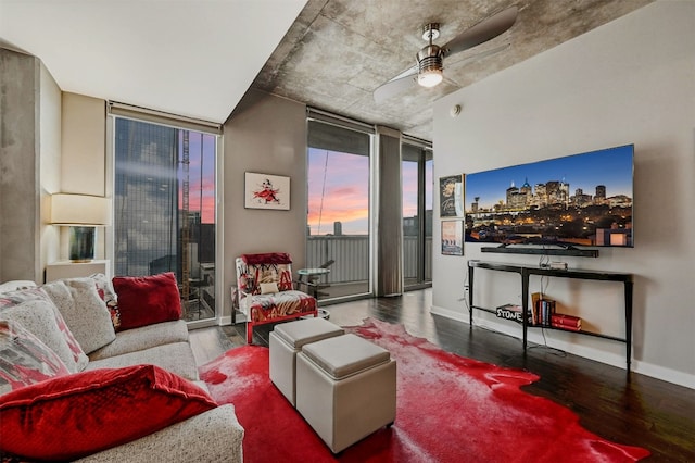 living room with hardwood / wood-style floors, a wall of windows, and ceiling fan