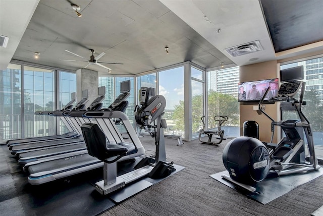 exercise room featuring ceiling fan and floor to ceiling windows