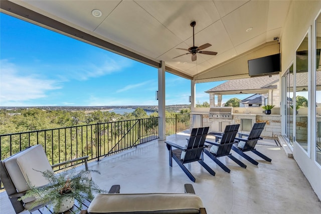 view of patio with area for grilling, ceiling fan, and exterior kitchen