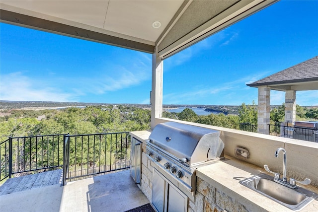 view of patio with area for grilling and sink