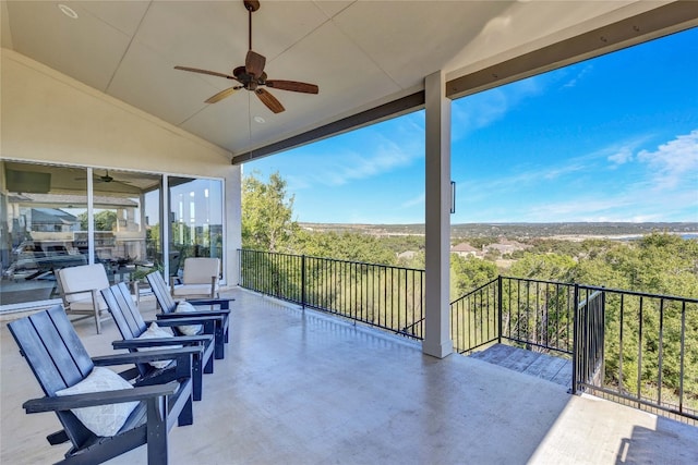 view of patio with a balcony and ceiling fan