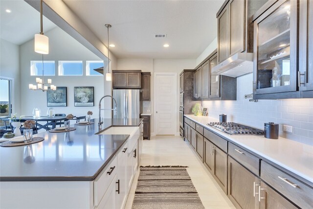 kitchen with pendant lighting, an inviting chandelier, decorative backsplash, white cabinetry, and stainless steel appliances