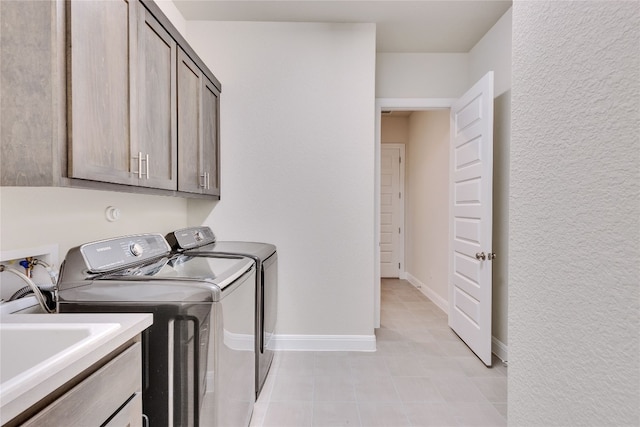 laundry area with cabinets and washing machine and dryer