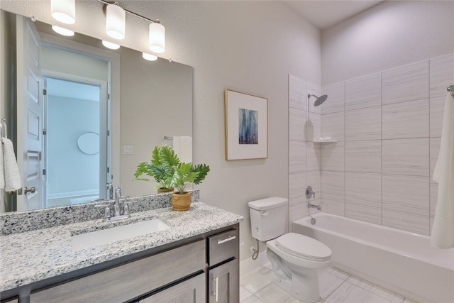 full bathroom featuring toilet, vanity, and tiled shower / bath