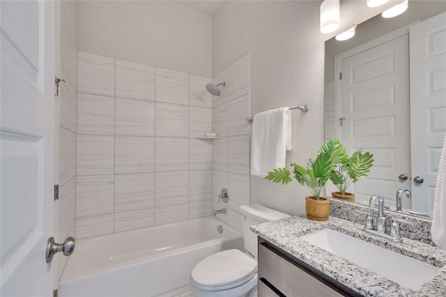 full bathroom featuring vanity, toilet, and tiled shower / bath