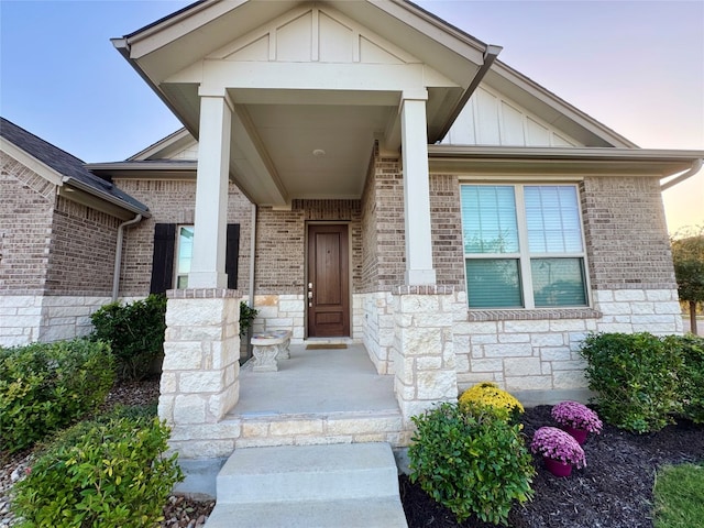 exterior entry at dusk featuring covered porch