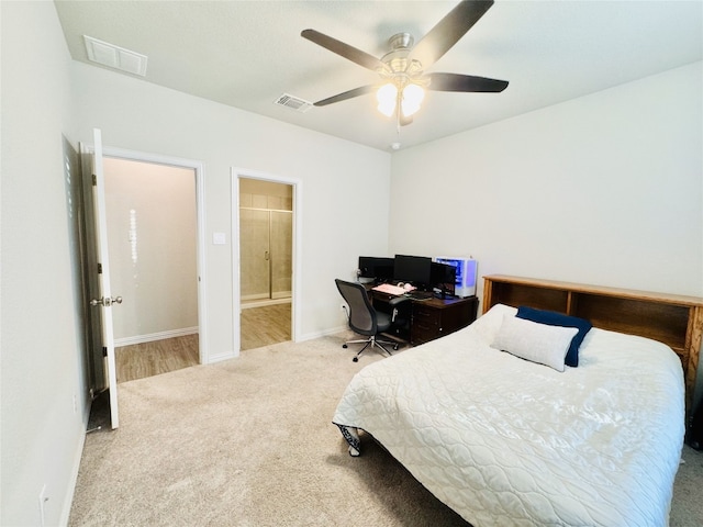 carpeted bedroom featuring ceiling fan and ensuite bathroom