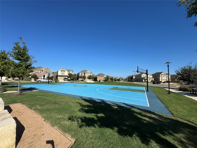 view of sport court featuring a yard