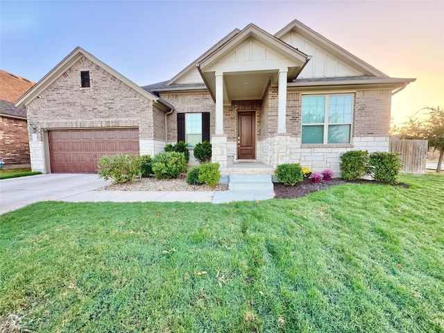 craftsman house with a garage and a yard