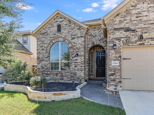 doorway to property featuring a garage