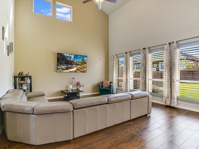 living room featuring high vaulted ceiling, ceiling fan, and dark wood-type flooring