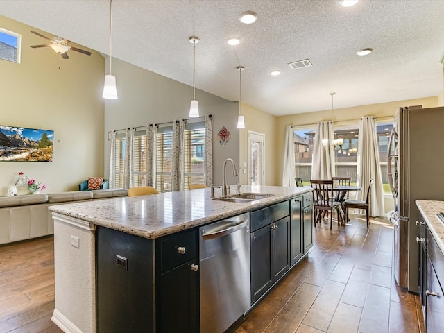 kitchen featuring appliances with stainless steel finishes, sink, a center island with sink, high vaulted ceiling, and dark hardwood / wood-style floors