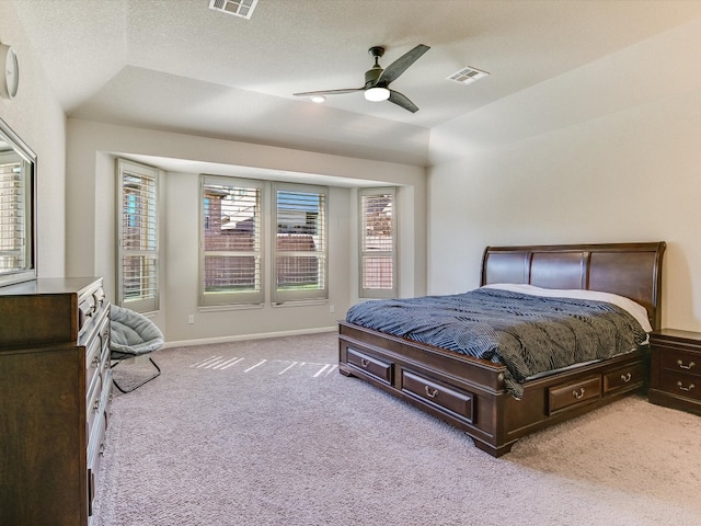 carpeted bedroom with a textured ceiling, ceiling fan, and vaulted ceiling