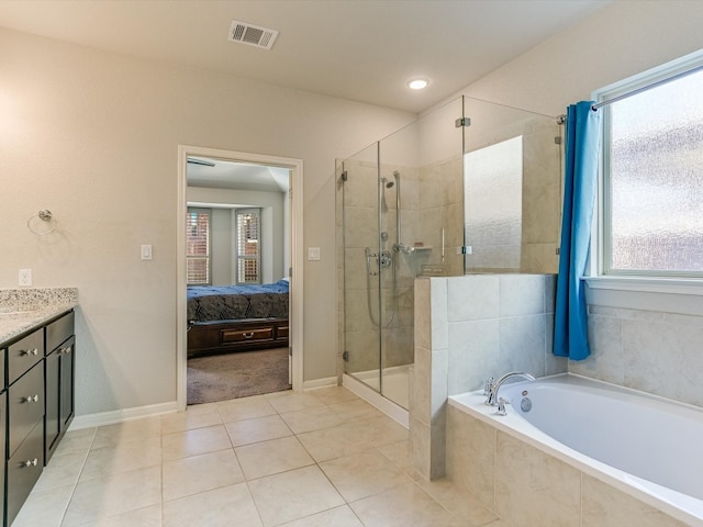 bathroom featuring tile patterned floors, vanity, and independent shower and bath