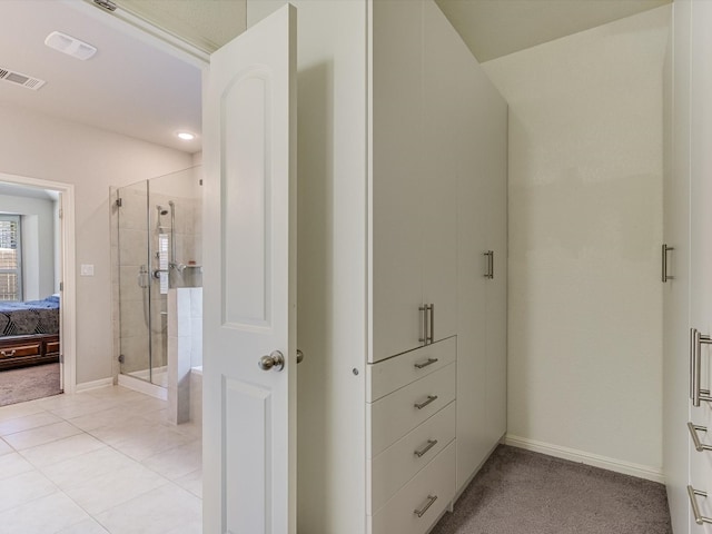 bathroom with tile patterned flooring and a shower with shower door