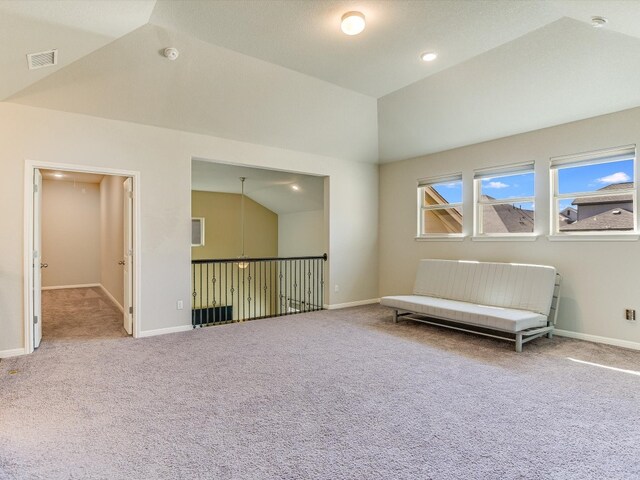 unfurnished room featuring carpet floors and lofted ceiling