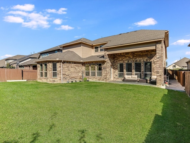 rear view of house with a lawn and an outdoor hangout area