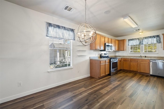 kitchen featuring decorative light fixtures, dark hardwood / wood-style flooring, stainless steel appliances, an inviting chandelier, and sink