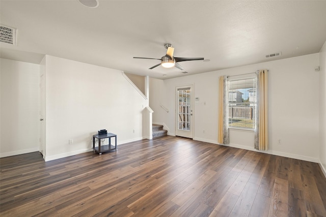 unfurnished living room with ceiling fan and dark hardwood / wood-style floors